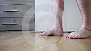 European man first steps after Achilles tendon rupture operation shows wound suture in the hospital showing stitches and operation