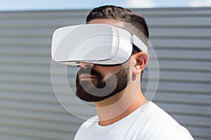 European man guy use computer technology person wear VR headset virtual reality goggles exploration metaverse modern