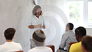 European man leads a lecture in the audience during a meeting of men gays.