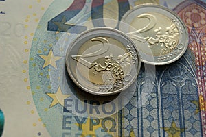 European money. 2 Euro coins on a banknote.