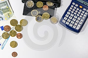 European money with black wallet on white desk as white background with different euro coins and euro bank notes with calculator f