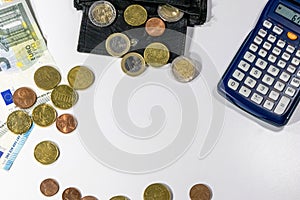 European money with black wallet on white desk as white background with different euro coins and euro bank notes with calculator f