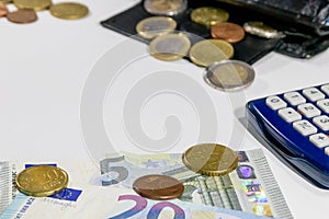 European money with black wallet on white desk as white background with different euro coins and euro bank notes with calculator f