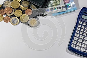 European money with black wallet on white desk as white background with different euro coins and euro bank notes with calculator f