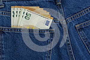 European money euro in jeans pocket background. Cash, money is in the pocket of blue jeans