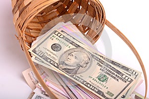 European money on wooden basket, hryvnia, dollars, euro