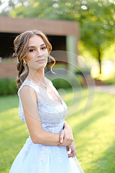 European nice bride walking in garden.