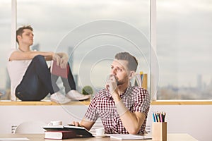 European businessmen reading book and doing paperwork