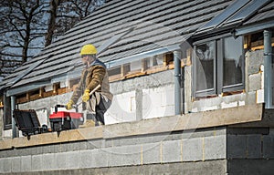 European Residential Construction and Worker with His Toolboxes