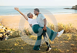 European Senior Couple Dancing Having Fun At Ocean Beach Outside