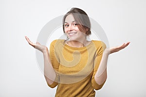 European student woman in gesture of asking over gray background