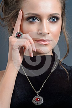 european style model wearing luxury accessory from silver. Isolated on dark blue background