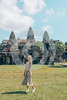 European tourist stands in Angkor Wat in Cambodia