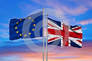 European Union and British Union Jack flag flying in front of bright blue sky in a backlit statement of the Brexit EU referendum