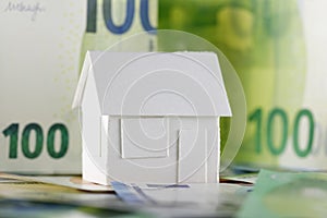 European Union currency and a detached house model