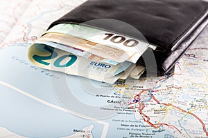 European union currency in a wallet on a map background