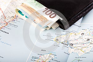 European union currency in a wallet on a map background
