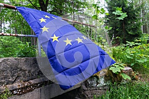 European Union EU flag in forest nature outdoor tree, czech german border