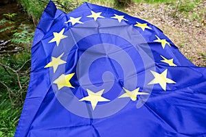 European Union EU flag in forest nature outdoor tree, czech german border