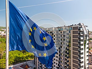 European union flag Against City Varna at summer day, Bulgaria
