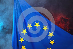 European union flag on red blue smoke background, symbol