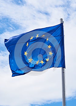 European Union flag with sky in the background vertical