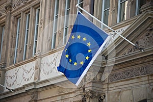 european union flag on the stoned facade of building