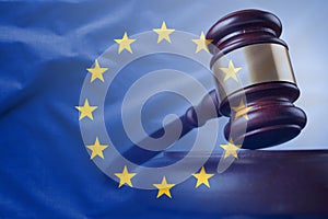 European Union flag with wooden gavel in close-up