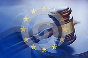 European Union flag with wooden gavel in close-up