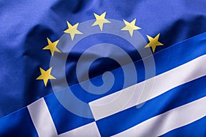 European Union and Greece. The concept of relationship between EU and Greece. Waving flag of EU and Greece