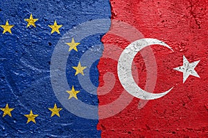 European Union and Turkey - Cracked concrete wall painted with a EU flag on the left and a turkish flag on the right stock photo