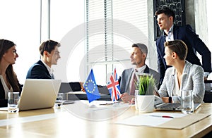 European Union and United Kingdom leaders shaking hands on a deal agreement.