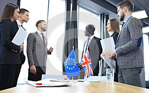 European Union and United Kingdom leaders shaking hands on a deal agreement.