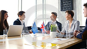 European Union and United Kingdom leaders shaking hands on a deal agreement.