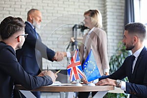 European Union and United Kingdom leaders shaking hands on a deal agreement. Brexit