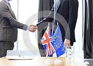 European Union and United Kingdom leaders shaking hands on a deal agreement. Brexit.