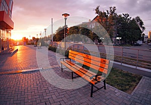 European urban sidewalk, benches and lanterns in the evening