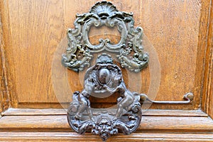 European Vintage old metal wrought iron door knocker. Design detail. Paris.