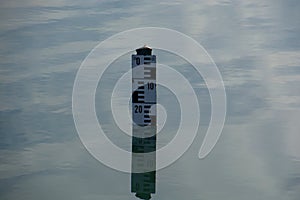European water depth sign on calm water surface, water level indicator show the depth of water in a lake