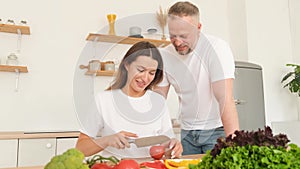 European woman cooking dinner for her husband, sincere love in a relationship. Couple in love