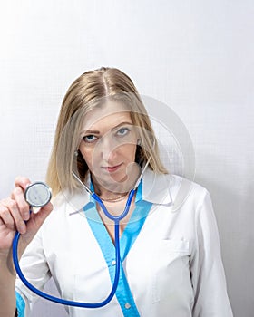 European woman doctor with phonendoscope, medical care, treatment and counseling