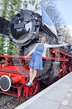 European woman expressing happiness for freedom and peace on steam train