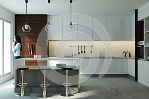 European woman in modern kitchen interior