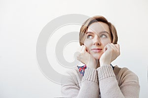 European woman pensively looks to the side.