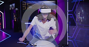 European woman in virtual reality glasses controls a motorcycle