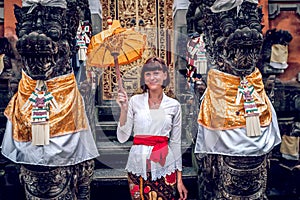 European young woman in balinese traditional temple. Bali island.