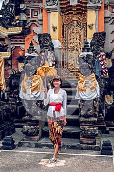 European young woman in balinese traditional temple. Bali island.