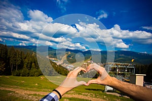 Europen lover couple woman and man travel nature. hand heart-shaped. With nature on mountain