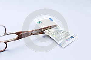 Euros banknote and a scissors