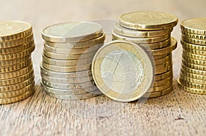 Euros and cents coins on wooden background